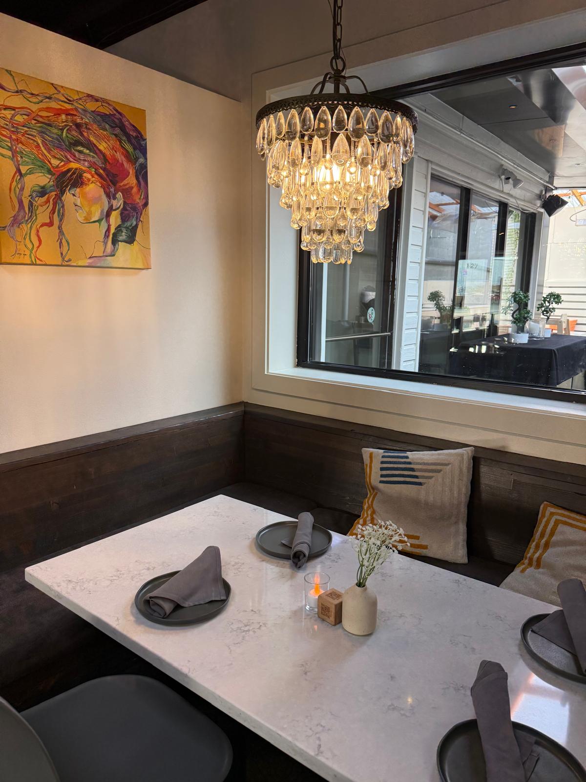 Cozy corner booth with crystal chandelier