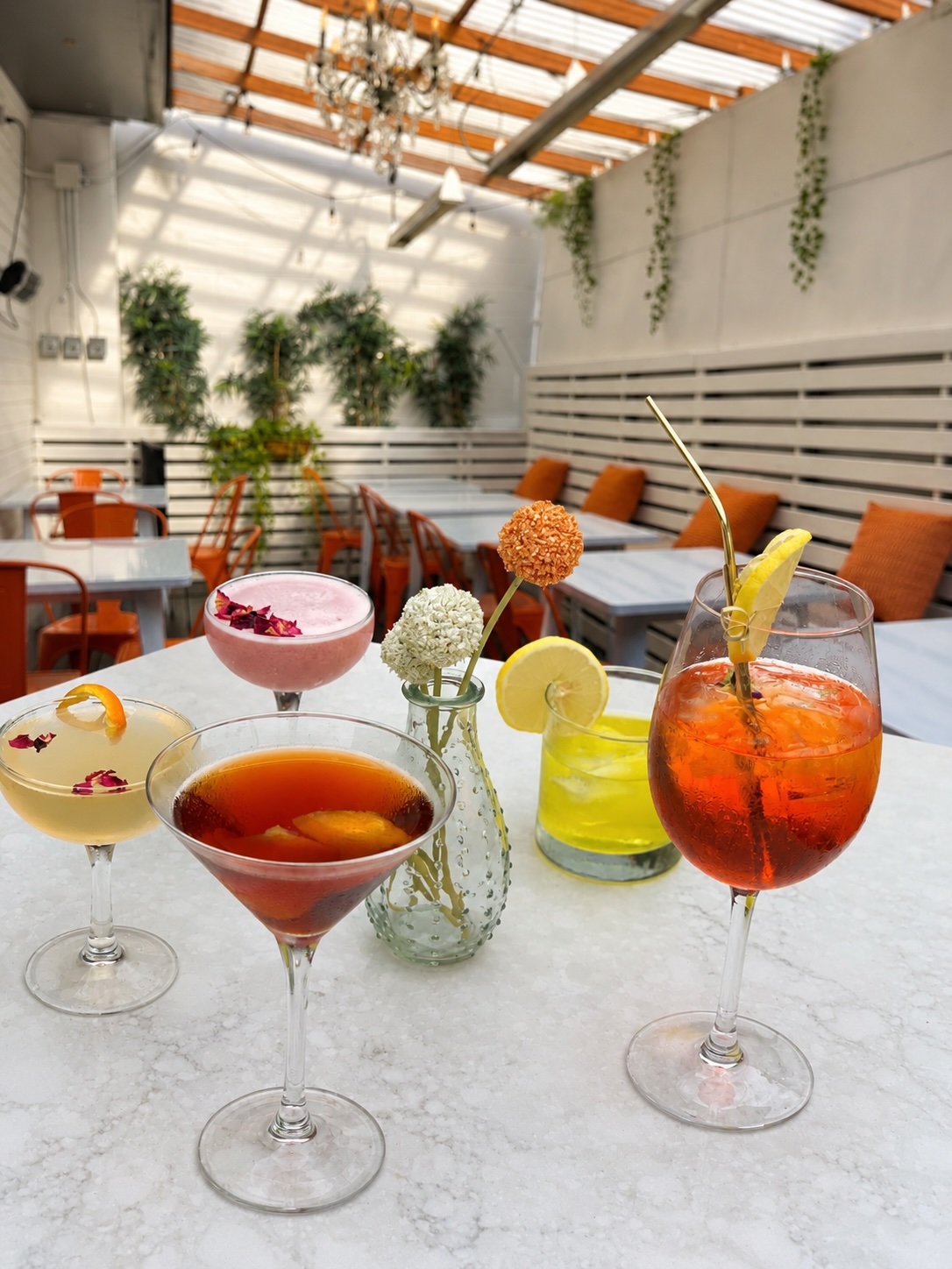 Craft cocktails on a marble table in the patio
